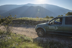 Rewilding Apennines team driving in 4WD car to monitor wildlife in corridor area between Abruzzo, Lazio and Molise National Park and Majella National Park. Central Apennines, Italy. 2020
